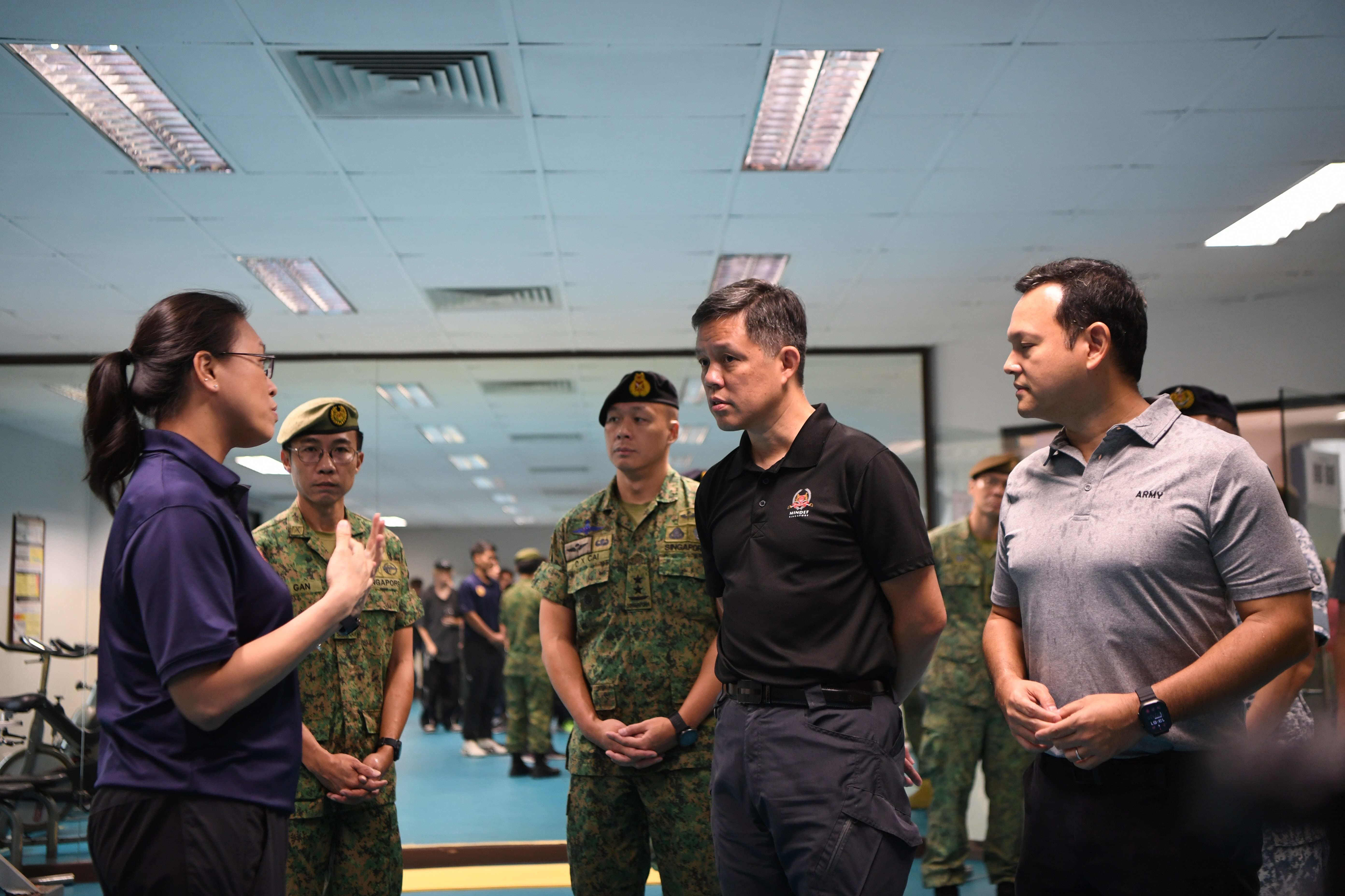 Mr Chan speaking to a physiotherapist at the Tekong Physiotherapy Centre.
